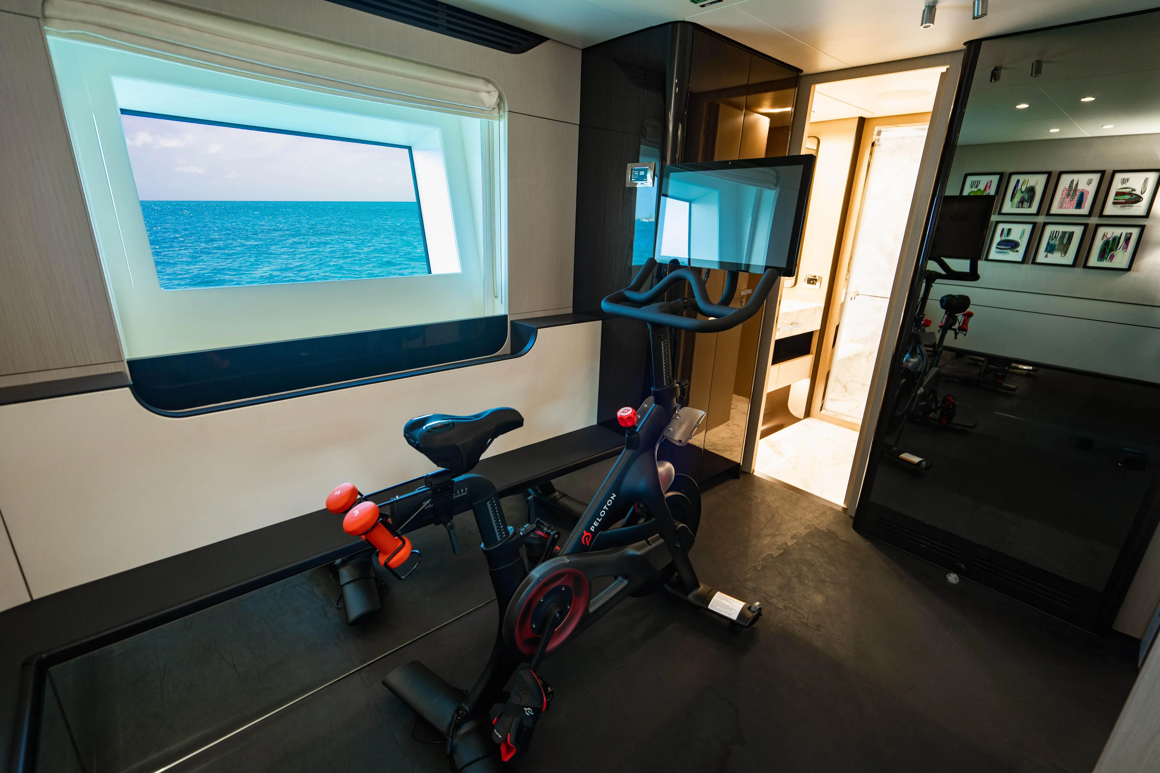 Carpe Diem Yacht Photos Pics Luxury yacht interior with exercise bike, ocean view window, and modern decor, Azimut 2023.