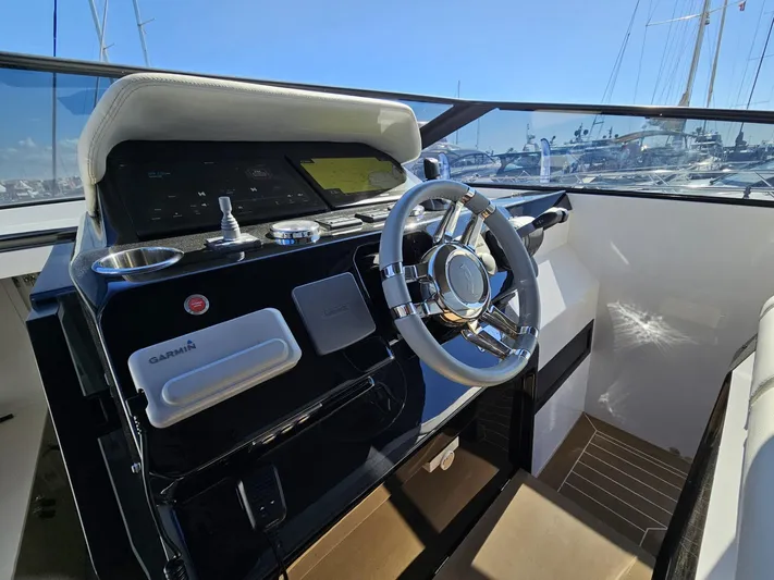 Rio 50 Yacht Photos Pics 2024 Rio Yachts Daytona 50 helm with modern controls and sleek steering wheel.
