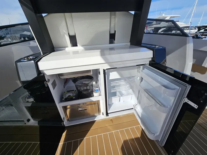Rio 50 Yacht Photos Pics 2024 Rio Yachts Daytona 50 interior with open fridge and storage compartments.