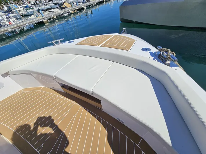 Rio 50 Yacht Photos Pics 2024 Rio Yachts Daytona 50 deck with cushioned seating at marina.