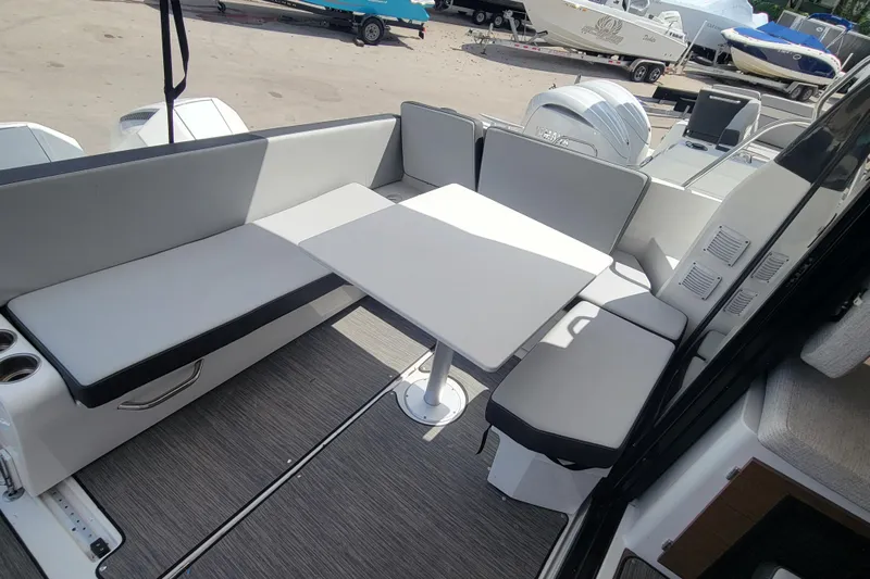 Tagwood Bbq Yacht Photos Pics 2023 Jeanneau NC 895 boat interior with seating and table in a modern design.