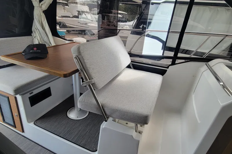 Tagwood Bbq Yacht Photos Pics Interior of 2023 Jeanneau NC 895 boat with seating and table.
