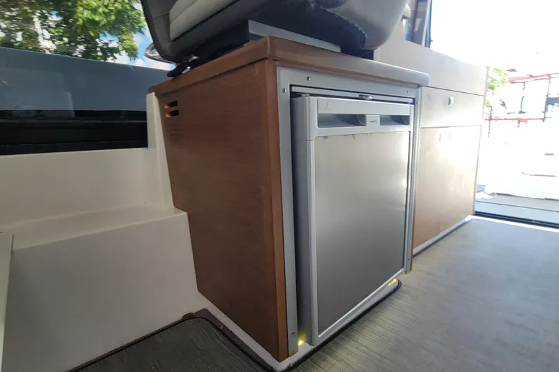 Tagwood Bbq Yacht Photos Pics Interior of 2023 Jeanneau NC 895 boat featuring a compact refrigerator.