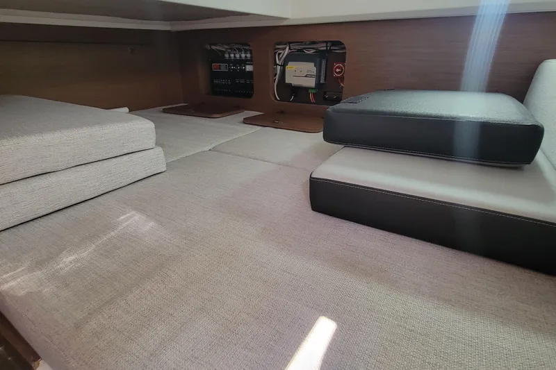 Tagwood Bbq Yacht Photos Pics Interior cabin of 2023 Jeanneau NC 895 with cushions and control panel.
