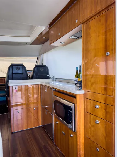  Yacht Photos Pics Luxurious 2012 Riviera 50SY yacht interior with modern kitchen and wooden cabinetry.