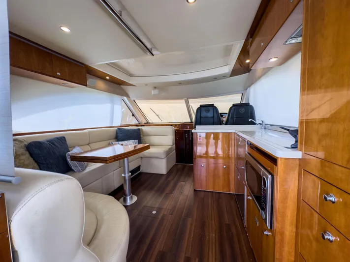  Yacht Photos Pics Luxurious interior of 2012 Riviera 50SY yacht with elegant wood finishes and modern seating.