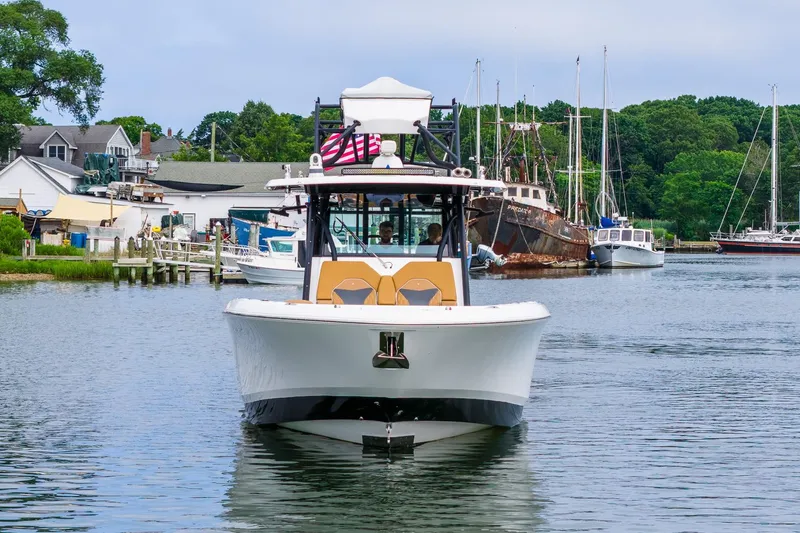  Yacht Photos Pics 2021 Wellcraft 402 Fisherman boat docked in a scenic marina setting.