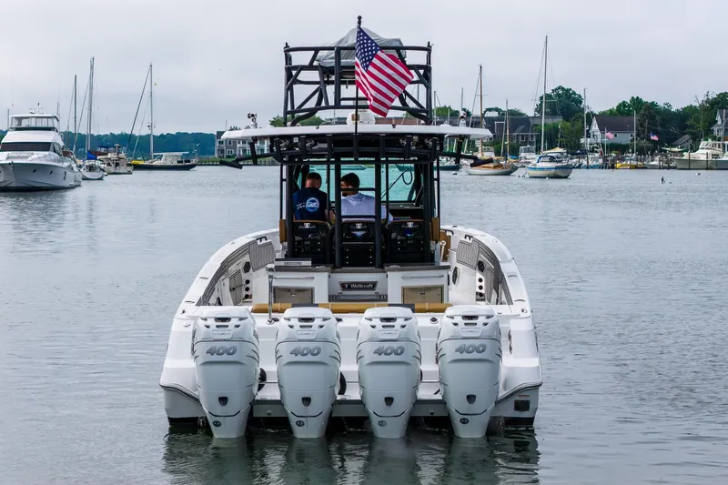  Yacht Photos Pics 2021 Wellcraft 402 Fisherman boat with quad engines, docked in a marina.