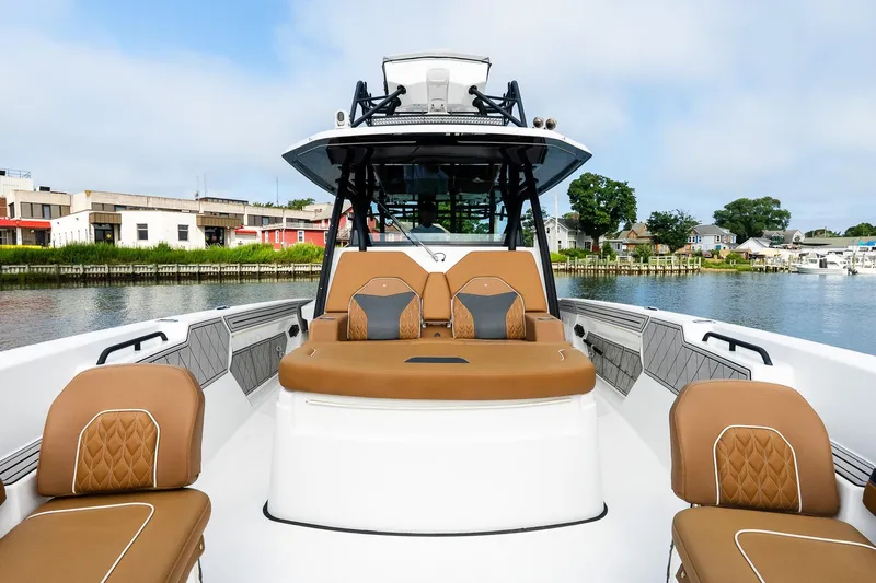  Yacht Photos Pics 2021 Wellcraft 402 Fisherman boat with luxurious seating, docked by a scenic waterfront.