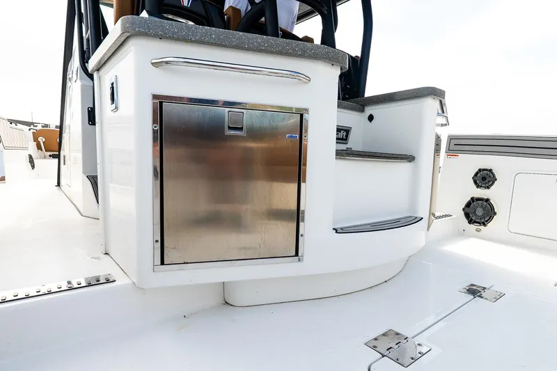  Yacht Photos Pics 2021 Wellcraft 402 Fisherman boat interior with stainless steel storage and seating area.