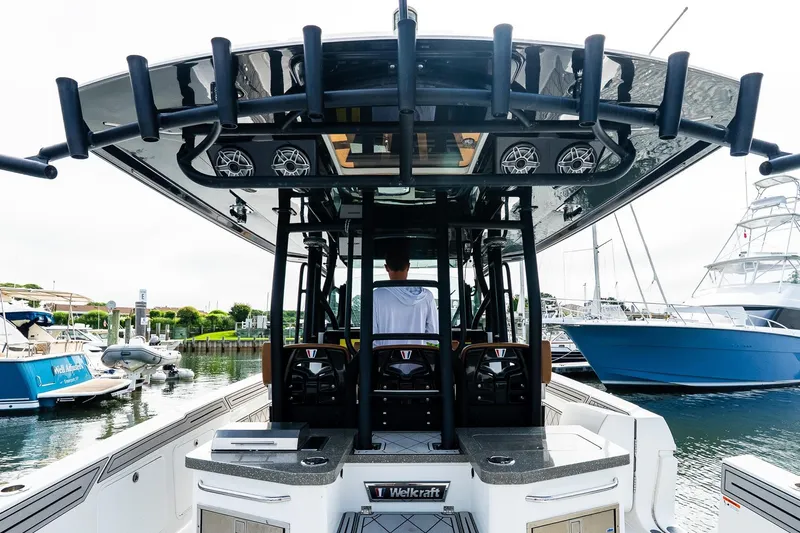  Yacht Photos Pics 2021 Wellcraft 402 Fisherman boat docked at marina, featuring sleek design and modern amenities.