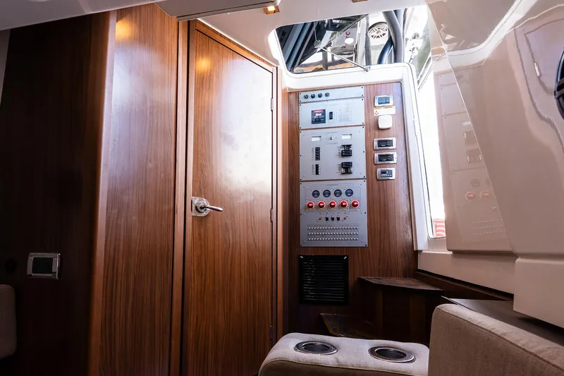  Yacht Photos Pics Interior of 2021 Wellcraft 402 Fisherman boat with control panel and wooden finish.