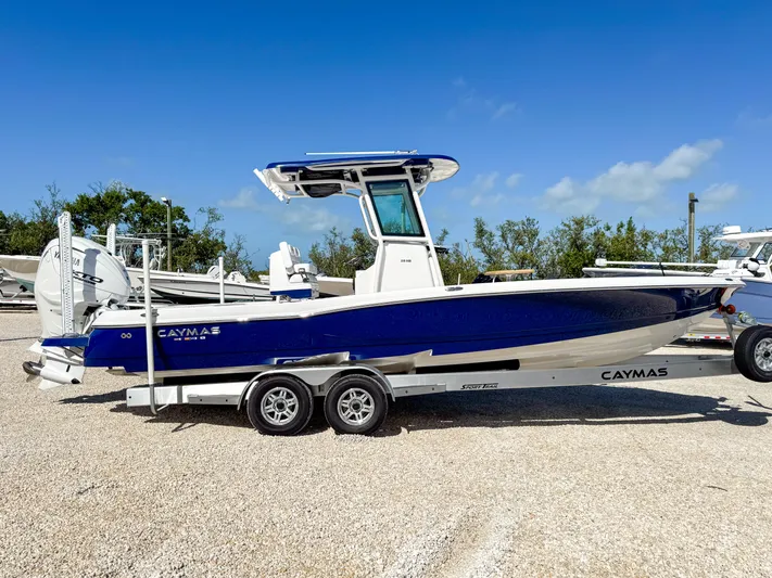  Yacht Photos Pics 2024 Caymas 28 HB boat on a trailer, blue and white, side view.
