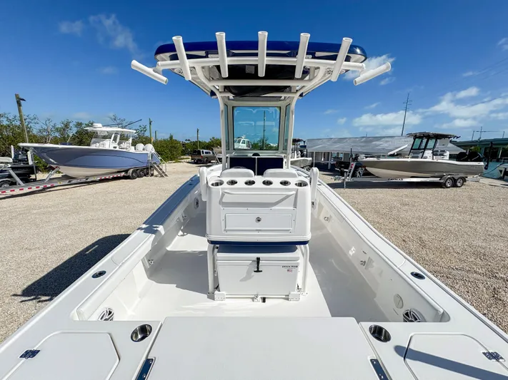  Yacht Photos Pics 2024 Caymas 28 HB boat with center console and T-top in a marina.