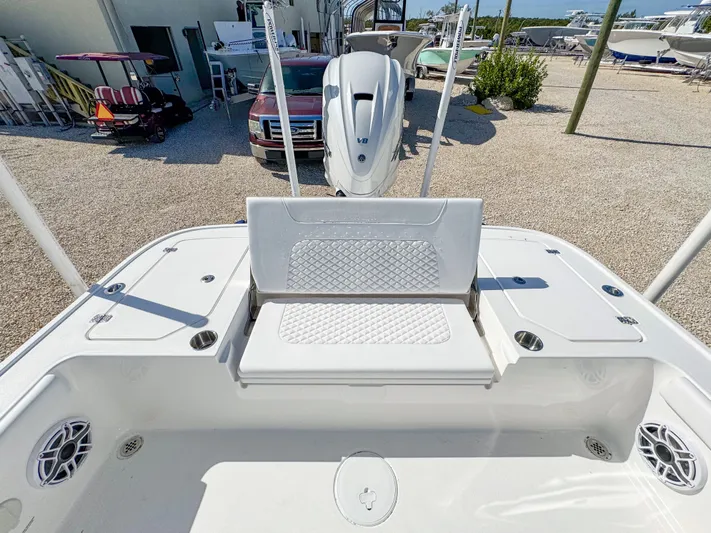  Yacht Photos Pics 2024 Caymas 28 HB boat with white seating and deck, parked in a marina.