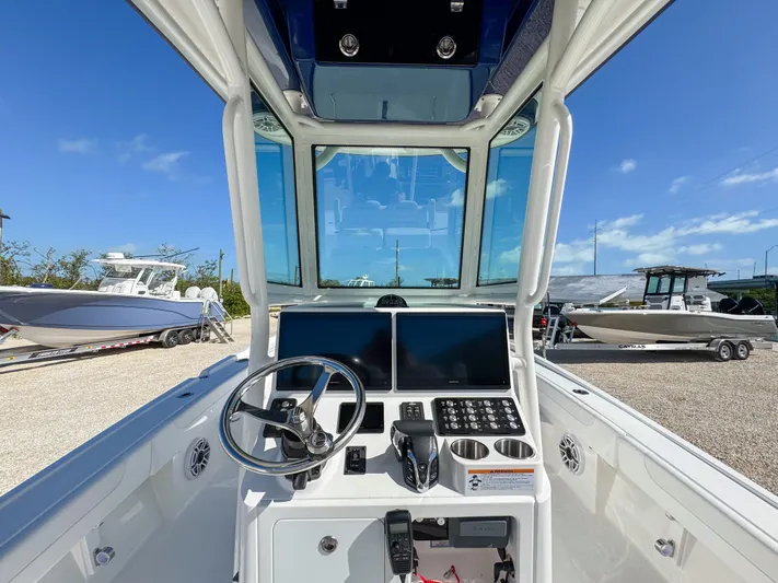  Yacht Photos Pics 2024 Caymas 28 HB boat helm with dual screens and steering wheel.