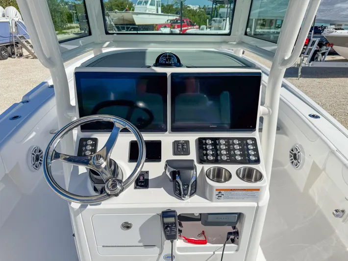  Yacht Photos Pics 2024 Caymas 28 HB boat dashboard with dual screens and steering wheel.