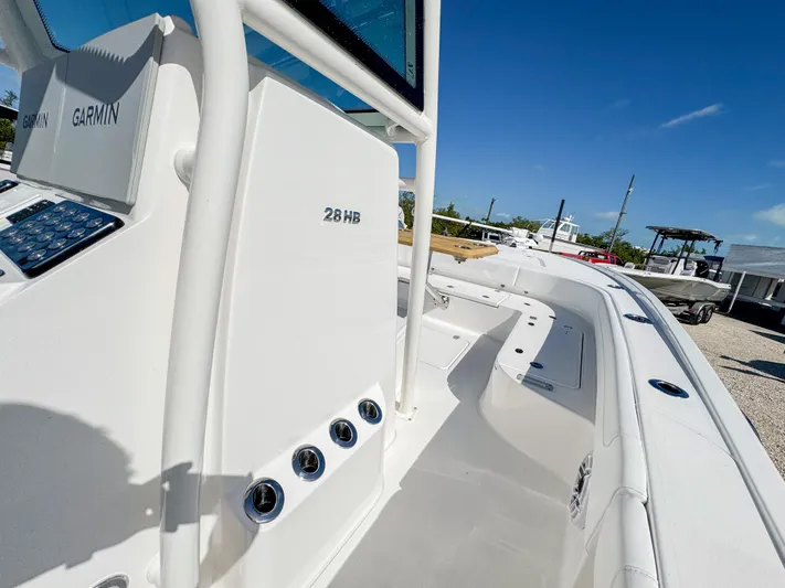  Yacht Photos Pics 2024 Caymas 28 HB boat console and deck view under clear blue sky.