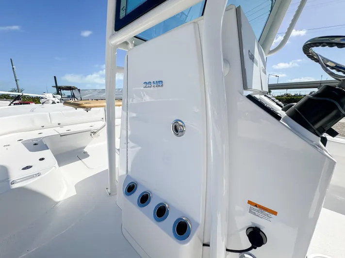  Yacht Photos Pics 2024 Caymas 28 HB boat console with rod holders and storage compartment.