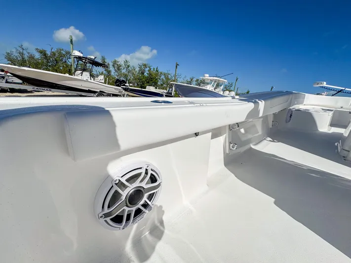  Yacht Photos Pics 2024 Caymas 28 HB boat interior with speaker, white deck, and blue sky background.
