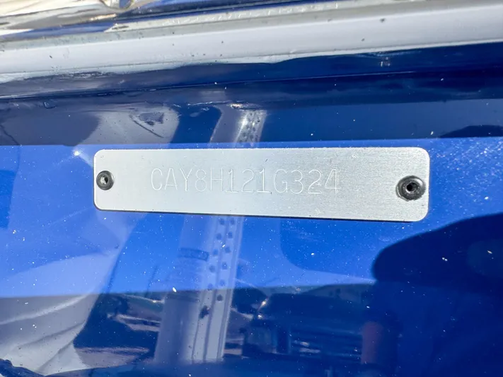  Yacht Photos Pics 2024 Caymas 28 HB boat identification plate on blue hull.