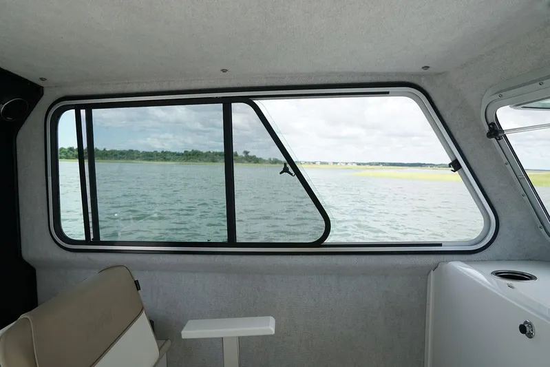  Yacht Photos Pics Manufacturer Provided Image: Interior view of 2019 Parker 2520 XL Sport Cabin boat with window overlooking water.