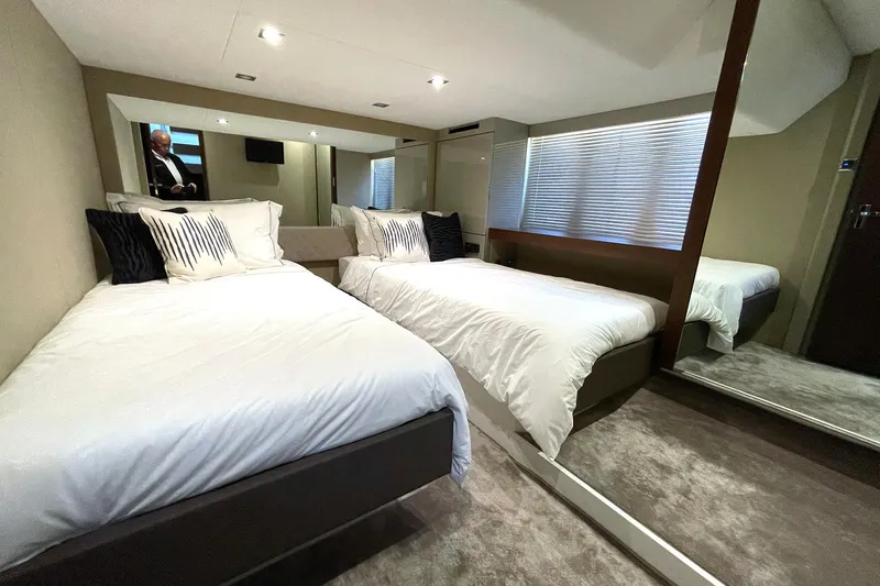  Yacht Photos Pics Luxurious twin bedroom in 2015 Fairline Targa 62 GT yacht, featuring modern decor and plush bedding.