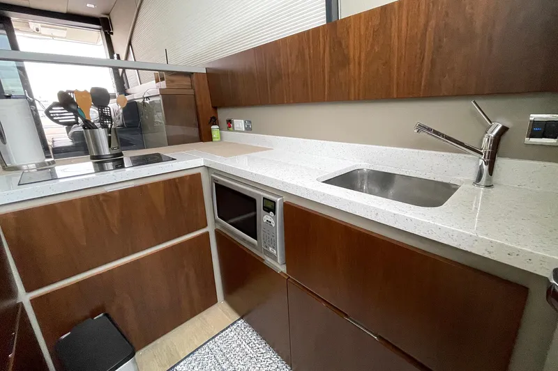  Yacht Photos Pics Modern kitchen in 2015 Fairline Targa 62 GT yacht with sleek countertops and wooden cabinetry.