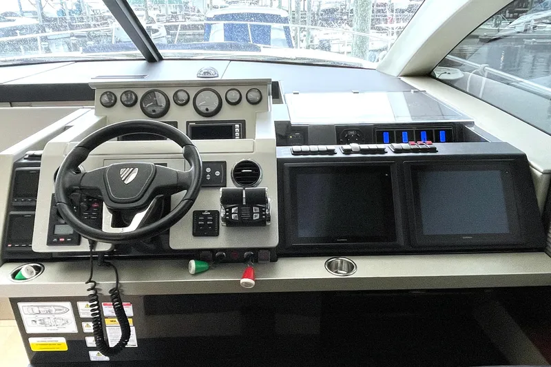 Yacht Photos Pics 2015 Fairline Targa 62 GT helm with steering wheel and navigation screens.