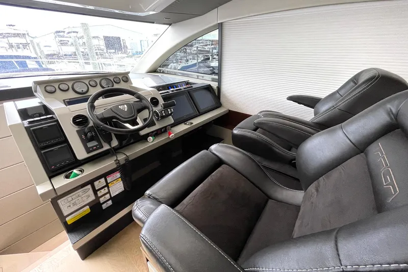  Yacht Photos Pics Luxury helm of 2015 Fairline Targa 62 GT yacht with leather seating and modern controls.