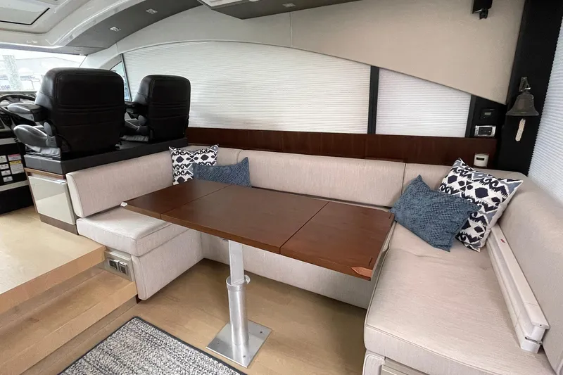  Yacht Photos Pics Luxurious interior of 2015 Fairline Targa 62 GT yacht with plush seating and wooden table.