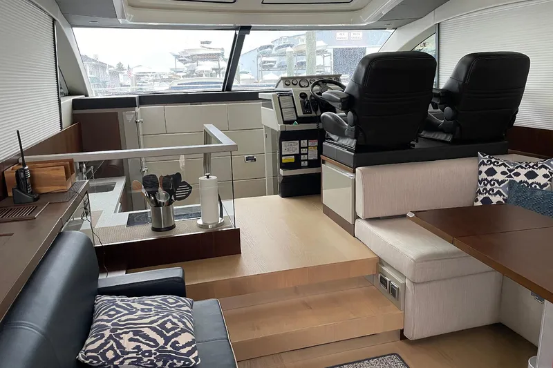  Yacht Photos Pics Luxurious interior of 2015 Fairline Targa 62 GT yacht with modern seating and helm.