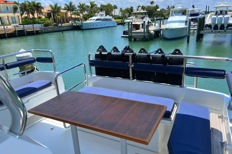 Maramor Yacht Photos Pics 2019 Sargo 33 All Season yacht with outdoor seating and table, docked in a marina.