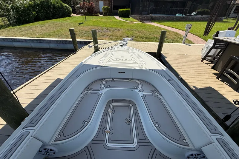  Yacht Photos Pics 2024 Contender 26 Bay boat docked, showcasing sleek deck design and spacious layout.