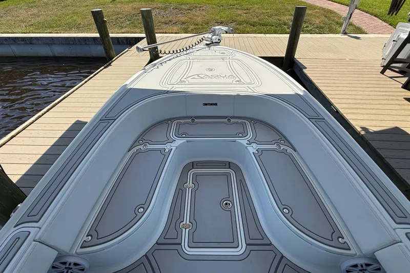  Yacht Photos Pics 2024 Contender 26 Bay boat docked, showcasing sleek deck design and spacious seating.