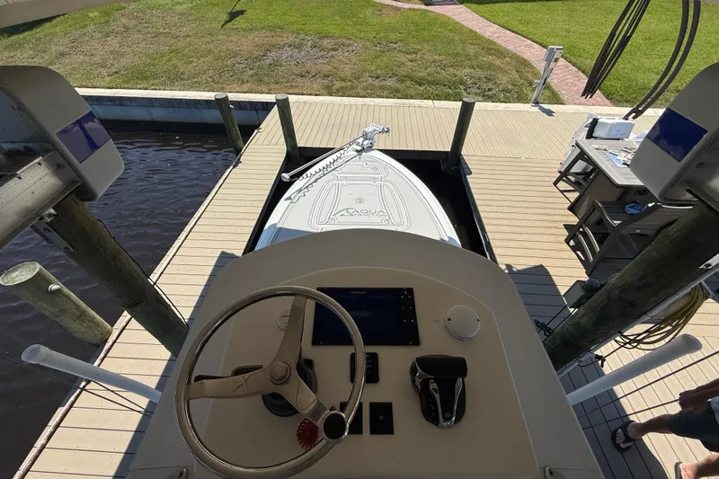  Yacht Photos Pics 2024 Contender 26 Bay boat docked, viewed from helm, with steering wheel and controls.