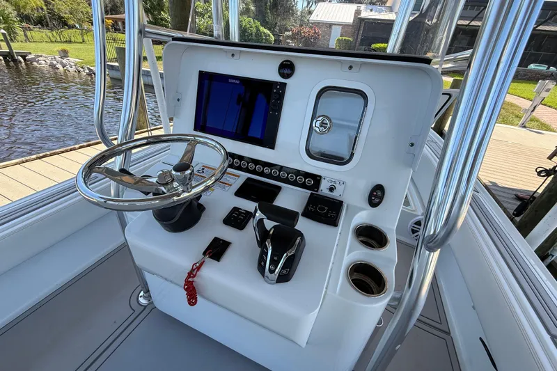  Yacht Photos Pics 2024 Contender 26 Bay boat console with steering wheel, controls, and navigation display.