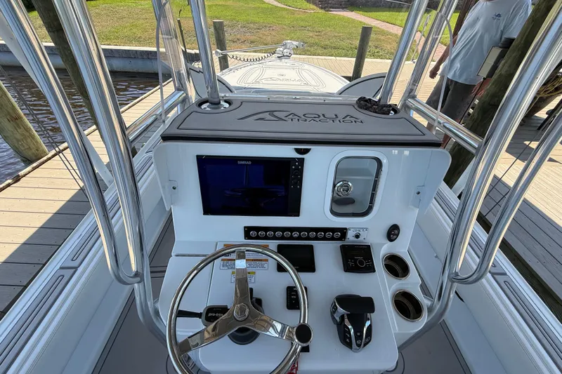  Yacht Photos Pics 2024 Contender 26 Bay boat console with steering wheel, controls, and navigation display.