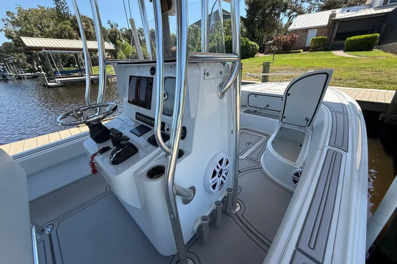  Yacht Photos Pics 2024 Contender 26 Bay boat interior with steering console and open storage compartment.