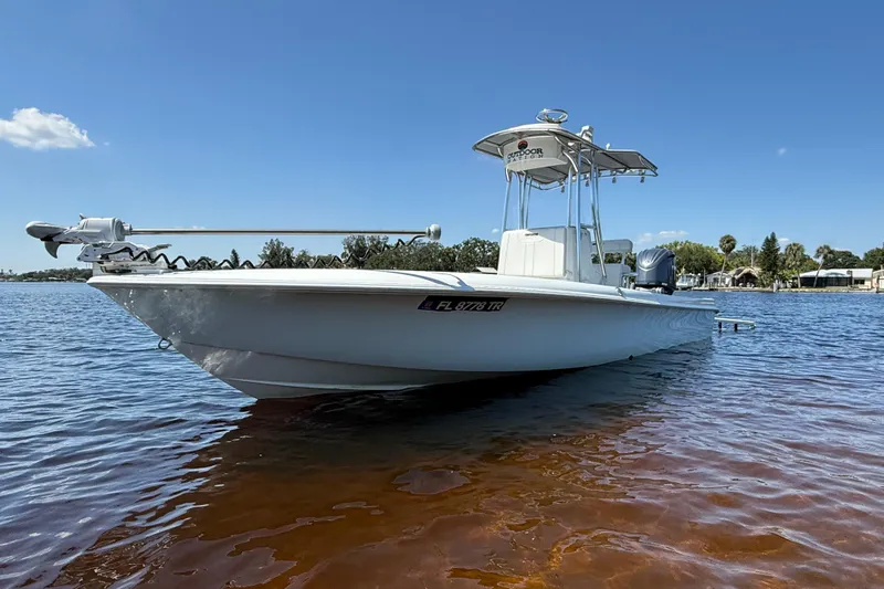  Yacht Photos Pics 2024 Contender 26 Bay boat on calm water under clear blue sky.