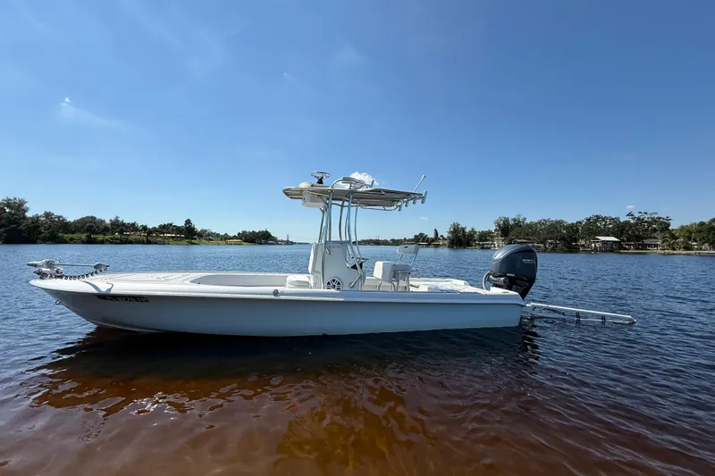  Yacht Photos Pics 2024 Contender 26 Bay boat on calm water under clear blue sky.