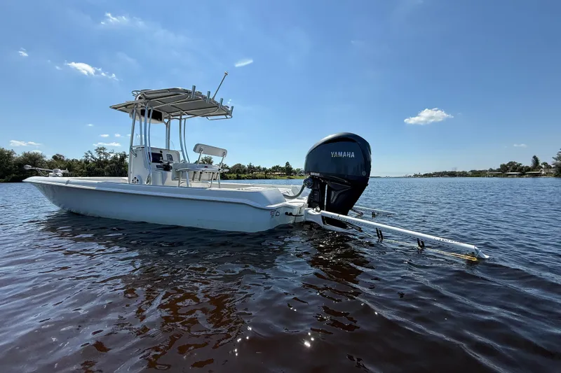  Yacht Photos Pics 2024 Contender 26 Bay boat with Yamaha engine on calm water.