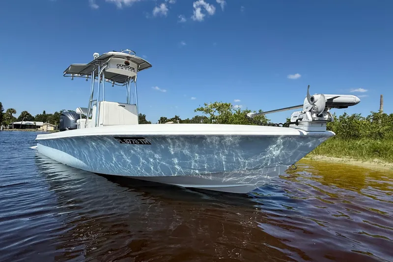  Yacht Photos Pics 2024 Contender 26 Bay boat on calm water under clear blue sky.