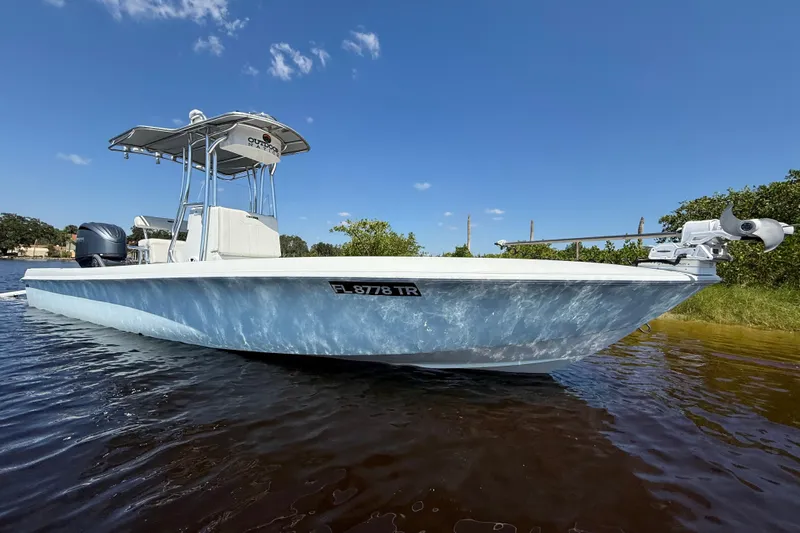  Yacht Photos Pics 2024 Contender 26 Bay boat on water, clear sky background.