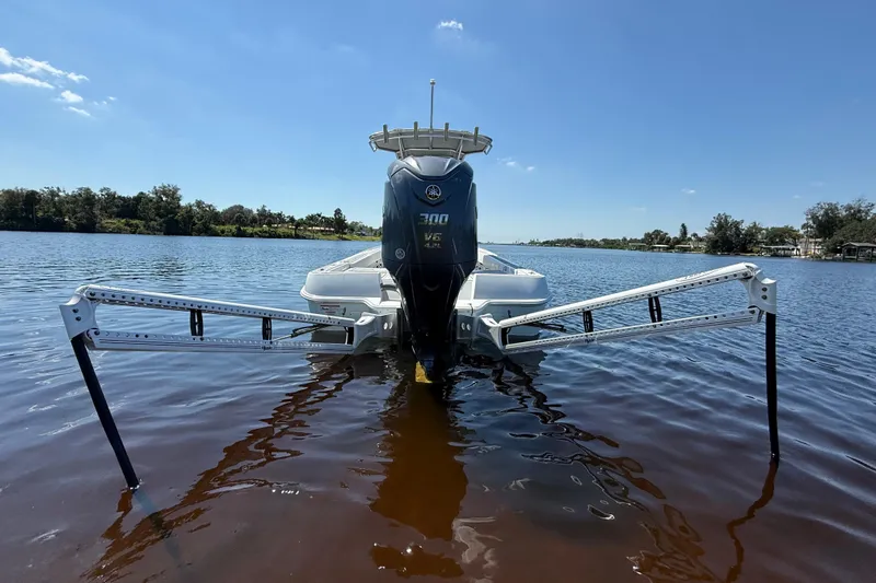  Yacht Photos Pics 2024 Contender 26 Bay boat with Yamaha 300 V6 engine on calm water.