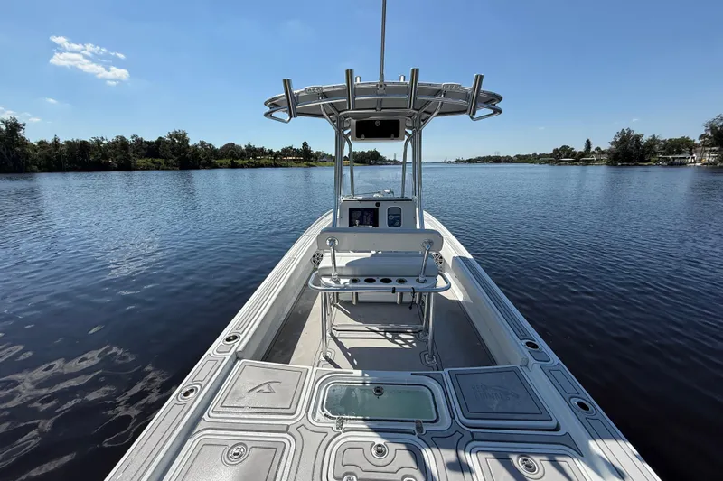  Yacht Photos Pics 2024 Contender 26 Bay boat on calm water, showcasing sleek design and spacious deck.