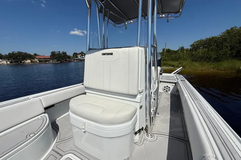  Yacht Photos Pics 2024 Contender 26 Bay boat interior with white seating and console, on calm water.