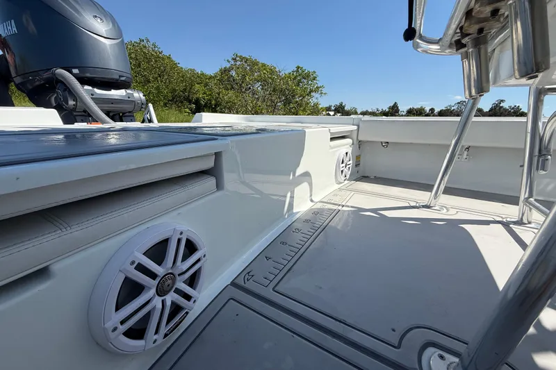  Yacht Photos Pics 2024 Contender 26 Bay boat interior with Yamaha engine, speakers, and seating.