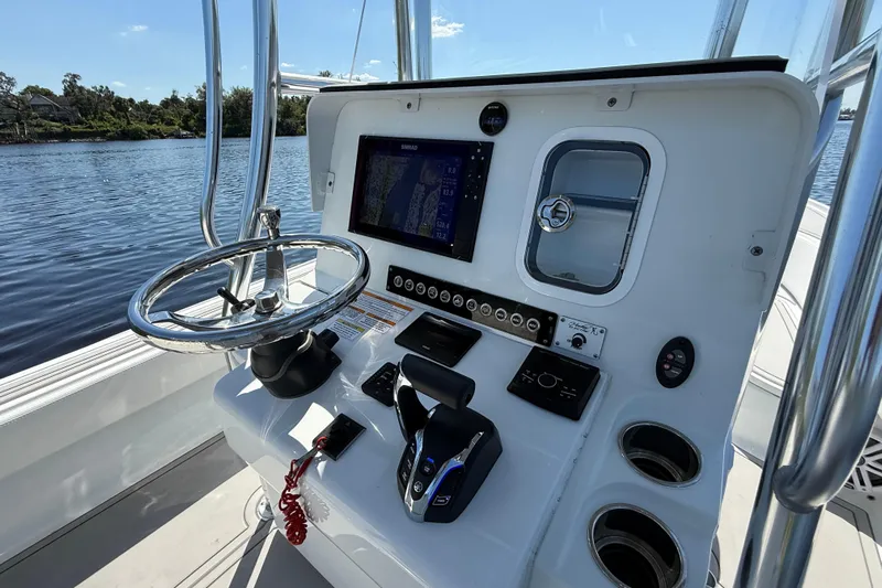  Yacht Photos Pics 2024 Contender 26 Bay boat helm with steering wheel and navigation controls.
