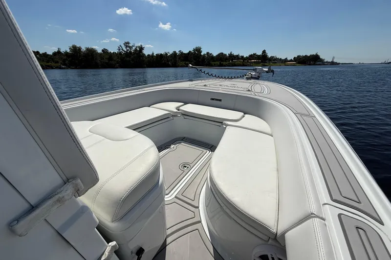  Yacht Photos Pics 2024 Contender 26 Bay boat interior with white seating on calm water.